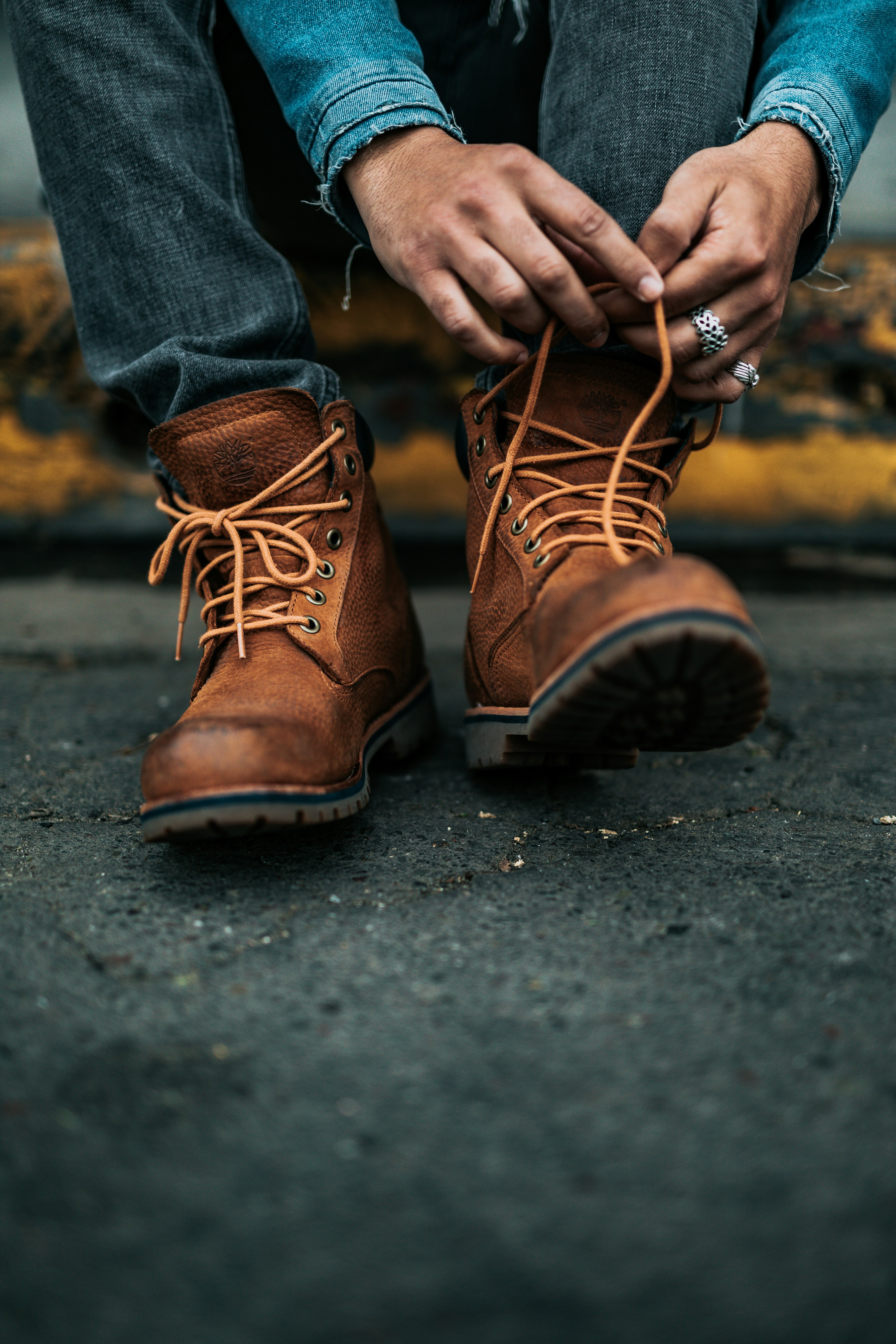 photography of person lacing his/her boots